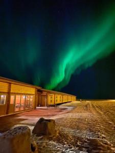 a building with the aurora in the sky at Lighthouse-Inn in Gardur