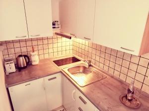 a kitchen with a sink and a counter top at Studio Sonja in Piran +12 photos