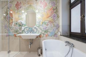 a bathroom with a sink and a mirror at Hotel Ester in Kraków