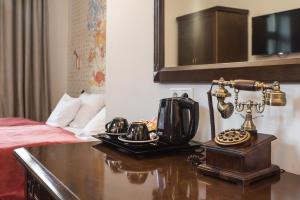 a hotel room with a telephone on a desk next to a bed at Hotel Ester in Kraków