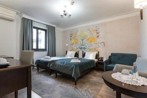 a hotel room with a bed and a chair and a table at Hotel Ester in Kraków