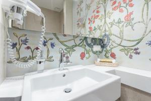 a bathroom with a sink and a mirror at Hotel Ester in Kraków