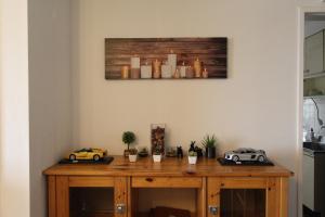 a wooden table with two toy cars on it at Sea View Court Kobe in Kobe