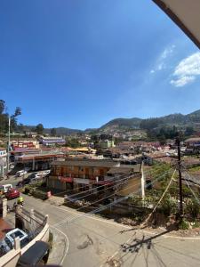 an aerial view of a city with a town at HOTEL VENUS in Ooty