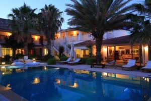 a hotel with a swimming pool at night at Sah Hotel in Bitez