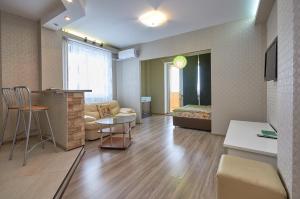 a living room with a couch and a table at Ochag Apartments in Magnitogorsk