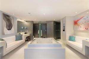 a bathroom with a large tub and two sinks at Double - Six, Luxury Hotel - Seminyak in Seminyak