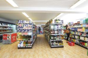 a woman is standing in a supermarket aisle at Happy Camp mobile homes in Camping Sènia Cala Canyelles in Lloret de Mar