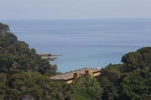 a building on a hill next to the ocean at Happy Camp mobile homes in Camping Sènia Cala Canyelles in Lloret de Mar