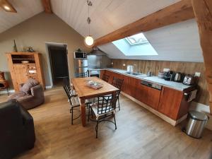 a kitchen with a table and chairs in a room at La fontaine des amis in Gap