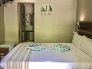 Postel nebo postele na pokoji v ubytování Hotel Ylang Ylang
