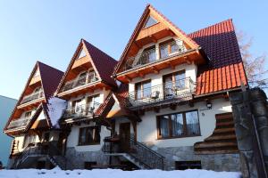 a building with snow in front of it at Willa Chaber in Zakopane