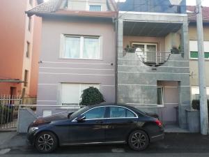 a black car parked in front of a house at Studio Apartment New Home in Zagreb