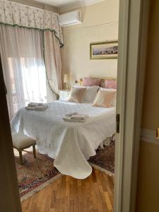 a bedroom with a bed with a white blanket and a window at I Citri in Taranto