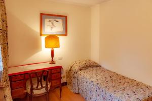 a bedroom with a bed and a table with a lamp at PALAZZO BERNARDO SAN POLO APARTMENT 100 MQ in Venice