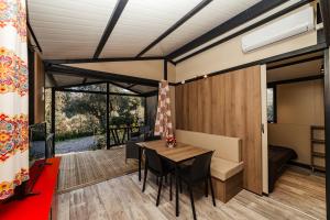 a room with a table and chairs in a tiny house at Oasi Camping in Diano Marina