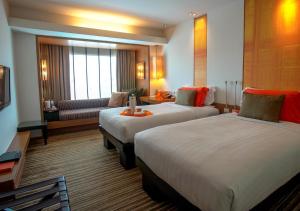 
a hotel room with two beds and two lamps at dusitD2 Chiang Mai - SHA Extra Plus in Chiang Mai
