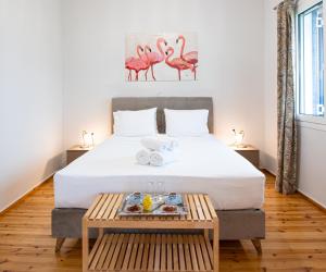 a bedroom with a bed with a tray of food on it at Blue Window in Finikounta