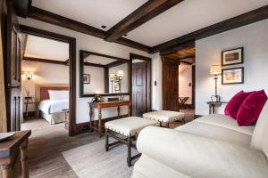 a hotel room with two beds and a mirror at Airelles Val d'Isère in Val-d'Isère