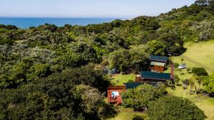 an aerial view of a house with the ocean in the background at Kingfisher Lakeside Retreat in Trafalgar