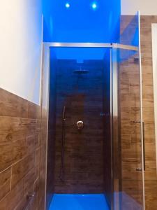 a shower with blue lighting in a bathroom at Bluemoon Sardinia in Cagliari