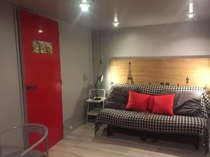 a bedroom with a bed with red pillows on it at au parc Montsouris in Paris