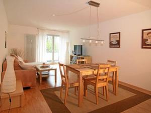 a living room with a table and chairs and a couch at Apartements im TSB Sportpark in Weil am Rhein
