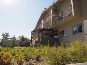 a building with a balcony on the side of it at Apartements im TSB Sportpark in Weil am Rhein