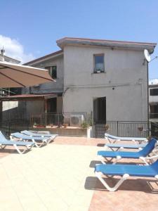 - une rangée de chaises longues assises sur une terrasse dans l'établissement Appartamenti Centro Policastro, à Policastro Bussentino