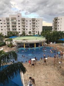 a group of people in a swimming pool at Condomínio Lagoa Quente Flat Service-Caldas Novas - FLAT TOP in Caldas Novas
