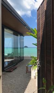 an external view of a house with a view of the ocean at DEEPSPACE cabin on Quiet Beach in Ko Lanta