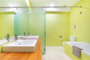 a bathroom with two sinks and a shower at WHome | Luxury Chiado Prime Apartment in Lisbon