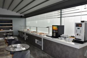 a restaurant with two tables and a counter with food at 4- you Family in Metamorfosi