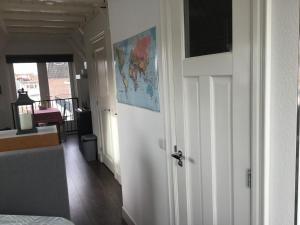 a room with a door with a map on the wall at B&B Alkmaars Toppunt in Alkmaar