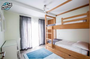 a bedroom with two bunk beds and a window at Ocean Two & Three Room Apartments in Peniche