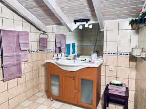 a bathroom with a sink and a mirror at Ermones Diamond Villa in Vátos +49 photos