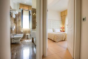 Postel nebo postele na pokoji v ubytování Hotel Nettuno