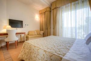 Postel nebo postele na pokoji v ubytování Hotel Nettuno