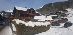 a ski lodge with snow on it in the mountains at Chalet Spillstatt in Grindelwald