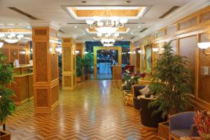 Un vestíbulo de un hotel con plantas en macetas. en شقق منصور بلازا للشقق المخدومة, en Dammam
