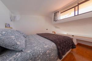 a small bedroom with a bed and a window at Radazul Marina Seafront 12 in Radazul +36 photos