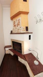 a living room with a brick fireplace with a lamp at Pit Stop Hostel in Poznań