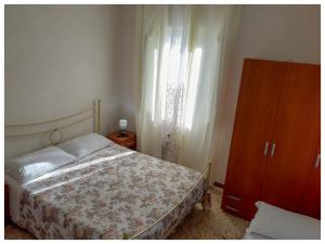 a bedroom with a bed and a dresser and a window at La casa dei 4 venti in Ponza