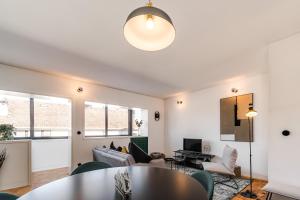 a living room with a table and chairs at Nomad's Family - 2BED Spacious Apartment Gaia in Vila Nova de Gaia