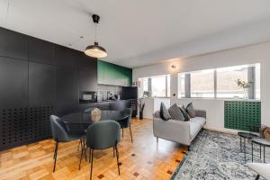 a kitchen and living room with a table and chairs at Nomad's Family - 2BED Spacious Apartment Gaia in Vila Nova de Gaia +8 photos