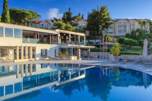 a hotel with a pool in front of a building at TUI BLUE Kalamota Island - Adults Only in Dubrovnik