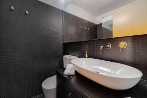 a bathroom with a sink and a toilet at Nomad's Family - 2BED Spacious Apartment Gaia in Vila Nova de Gaia
