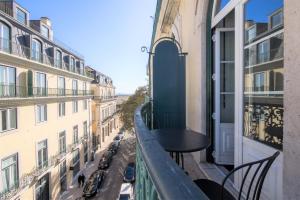 een balkon met een tafel en uitzicht op de stad bij Nomad's Fine Arts in Chiado with Garage in Lissabon