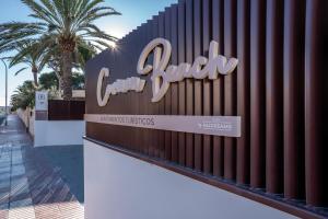 a sign for a car dealer in front of a fence at Alidreams Carmen Beach Apartamentos in El Campello