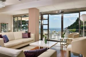 a living room with couches and a view of the ocean at Relais Paradiso in Vietri sul Mare